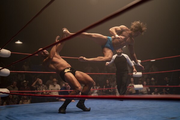 This image released by A24 shows Zac Efron, right, in a scene from "The Iron Claw." (Brian Roedel/A24 via AP)