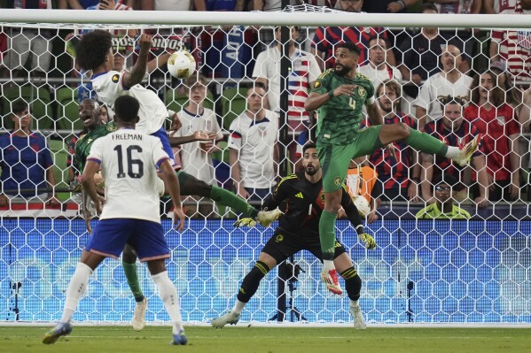Saudi Arabia's Nawaf Alaqidi (1) and Abdulelah Alamri (4) look to block a shot by United States' Chris Richards, left, during a CONCACAF Gold Cup soccer match, Thursday, June 19, 2025, in Austin, Texas. (AP Photo/Eric Gay)