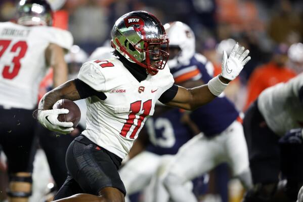 Western Kentucky wide receiver Malachi Corley (11) carries the ball against Auburn during the second half of an NCAA college football game, Saturday, Nov. 19, 2022, in Auburn, Ala. (AP Photo/Butch Dill)