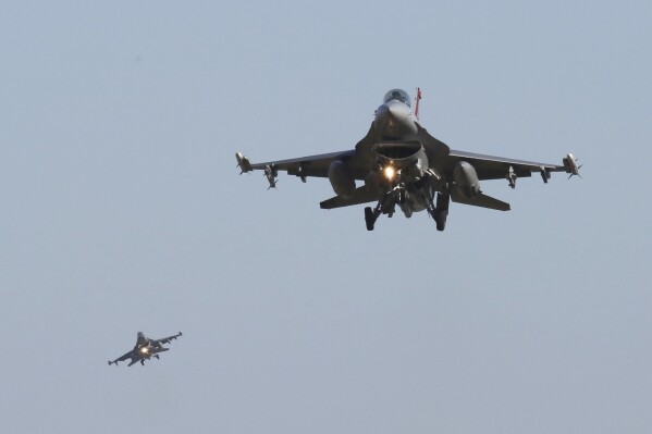 FILE - U.S. Air Force F-16 fighter jets fly over the Osan U.S. Air Base during a combined air force exercise with the United States and South Korea in Pyeongtaek, South Korea, Dec. 4, 2017. The U.S. could have the first Ukrainian pilots trained on F-16 fighter jets before the end of the year, though it will be longer than that before they are flying combat missions. That's according to the head of the Air National Guard force tasked with training them. (AP Photo/Ahn Young-joon, File)
