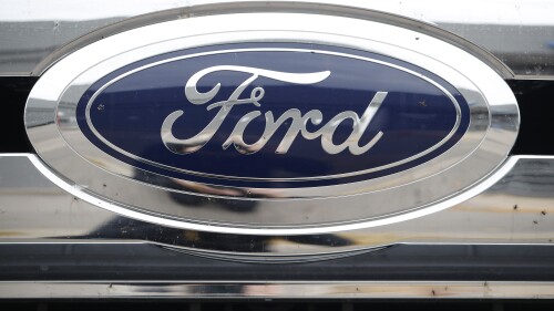 FILE - In this October 20, 2019 file photo, the company logo shines on the grill of an unsold vehicle at a Ford dealership in Littleton, Colorado. U.S. motor vehicle safety regulators are investigating complaints that the doors of some Ford Escapes may open while driving.  An SUV is being driven. A study by the U.S. Highway Traffic Safety Administration covered 346,000 getaways for the 2020 and 2021 model years. In a document posted on its website on Tuesday, July 11, 2023, the agency said it had 118 complaints about spot welds on door assembly brackets that could fail.  (AP Photo/David Zarbowski, File)