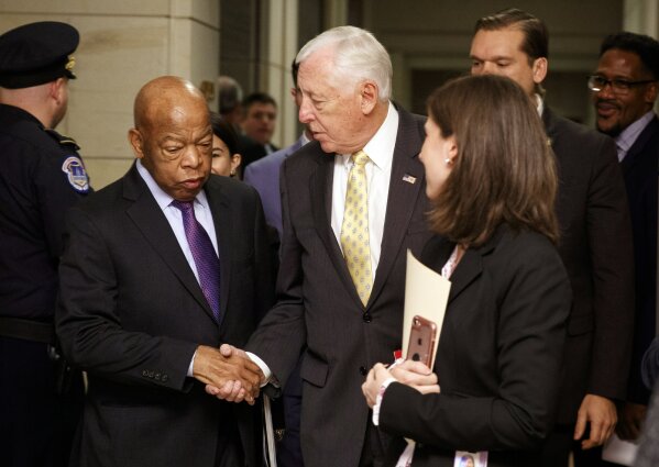
              House Minority Whip Steny Hoyer, D-Md., and Rep. John Lewis, D-Ga., shake hands as they walk from House Democratic leadership elections on Capitol Hill in Washington, Wednesday, Nov. 28, 2018.  (AP Photo/Carolyn Kaster)
            