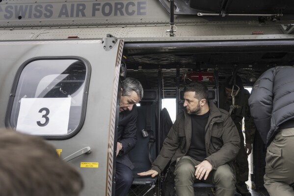 Switzerland's Foreign Minister Federal Councillor Ignazio Cassis, left, and Ukrainian President Volodymyr Zelenskyy sit in a helicopter of the Swiss Air Force after Zelenskyy's arrival at Zurich's Kloten airport, Switzerland, Monday, Jan. 15, 2024. Zelenskyy is in Switzerland to attend the World Economic Forum in Davos starting Tuesday. (Alessandro della Valle/Keystone via AP)