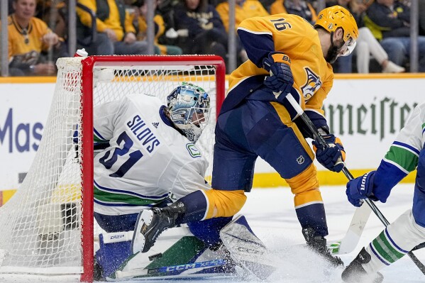 Vancouver Canucks goaltender Arturs Silovs (31) blocks a shot on goal by Nashville Predators left wing Jason Zucker (16) during the second period in Game 6 of an NHL hockey Stanley Cup first-round playoff series Friday, May 3, 2024, in Nashville, Tenn. (AP Photo/George Walker IV)