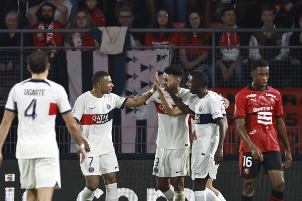 Paris Saint Germain players celebrate after PSG's Achraf Hakimi scored his side's second goal during the French League One soccer match between Rennes and Paris Saint Germain, at the Roazhon Park Stadium, in Rennes, France, Sunday, Oct. 8, 2023. (AP Photo/Jeremias Gonzalez)