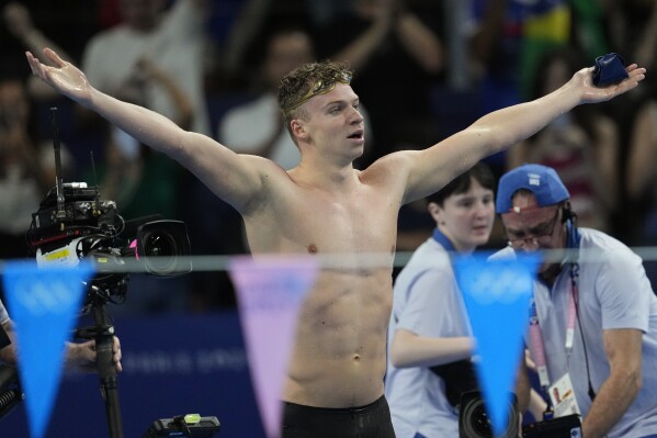 Leon Marchand of France, reacts after winning the men's 200-meter individual medley final at the 2024 Summer Olympics, Friday, Aug. 2, 2024, in Nanterre, France. (AP Photo/Ashley Landis)