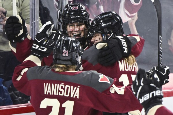 Montreal's Marie-Philip Poulin (29) celebrates her goal against New York with Tereza Vanisova (21) and Maureen Murphy during the third period of a PWHL hockey game Tuesday, Jan. 16, 2024, in Laval, Quebec. (Graham Hughes/The Canadian Press via AP)