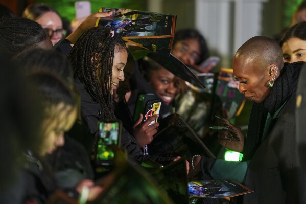 FILE - Cynthia Erivo signs autographs for fans at a photo call for the film 'Wicked' in London, Nov. 20, 2024. (Photo by Scott A Garfitt/Invision/AP File)