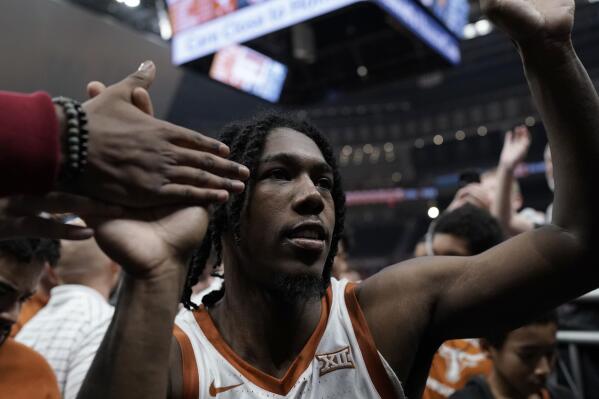 Texas guard Marcus Carr greets fans as he leaves the court following the team' NCAA college basketball game against Texas A&M-Commerce in Austin, Texas, Tuesday, Dec. 27, 2022. (AP Photo/Eric Gay)