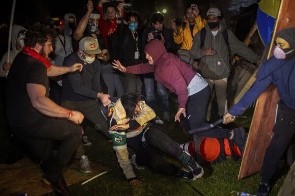 FILE - Demonstrators clash at an encampment at UCLA early Wednesday, May 1, 2024, in Los Angeles. The police chief at the University of California, Los Angeles, has been reassigned amid criticism of his handling of campus demonstrations. (AP Photo/Ethan Swope, File)