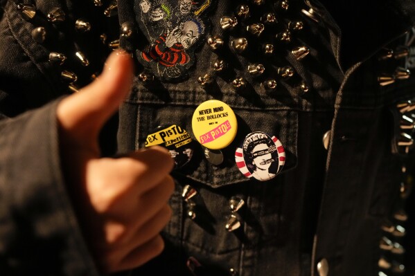 A Chinese punk, wearing a metal-studded jacket with buttons, attends a punk festival in Hangzhou, China, Friday, Jan. 17, 2025. (AP Photo/Aaron Favila)