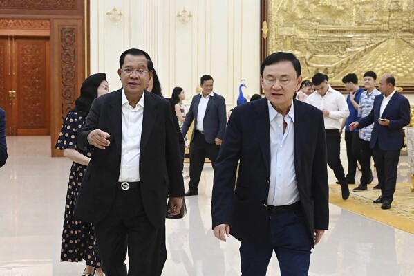 In this photo provided by Cambodia's Prime Minister Telegram, Cambodian Prime Minister Hun Sen, left, walks together with former Thai Prime Minister Thaksin Shinawatra, right, during a meeting at Hun Sen's residents in Takhmua, Kandal province southeast Phnom Penh Phnom Penh, Cambodia, Suaturday, Aug. 5, 2023. Thaksin attended a birthday party for outgoing Cambodian Prime Minister Hun Sen in Phnom Penh, according to video posted online Sunday, Aug. 6, a day after Thaksin said he would delay plans to return to Thailand following years of self-imposed exile. (Cambodia's Prime Minister Telegram via AP)