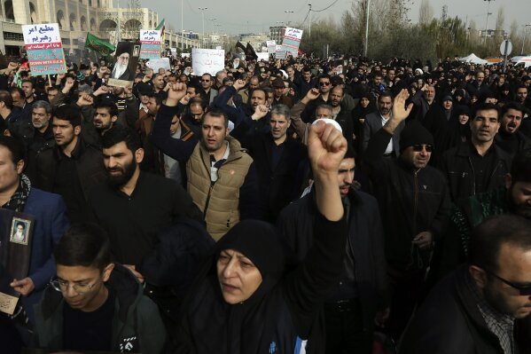 Protesters chant slogans during a demonstration over the U.S. airstrike in Iraq that killed Iranian Revolutionary Guard Gen. Qassem Soleimani in Tehran, Iran, Jan. 3, 2020. Iran has vowed "harsh retaliation" for the U.S. airstrike near Baghdad's airport that killed Tehran's top general and the architect of its interventions across the Middle East, as tensions soared in the wake of the targeted killing. (AP Photo/Vahid Salemi)