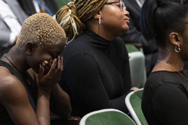 Guests gather during a public commemoration service for 19 unidentified Black Philadelphians whose remains were part of a display at the University of Pennsylvania's Penn Museum on Saturday, Feb. 3, 2024, in Philadelphia. As part of a growing effort among museums to reevaluate the curation of human remains, the Ivy League school laid some of the remains to rest last week. (AP Photo/Joe Lamberti)