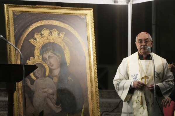 Cardinal Angelo De Donatis prays in St. Peter's Square, at the Vatican, during a vigil rosary for the recovery of Pope Francis, Tuesday, March 18, 2025. (AP Photo/Gregorio Borgia)
