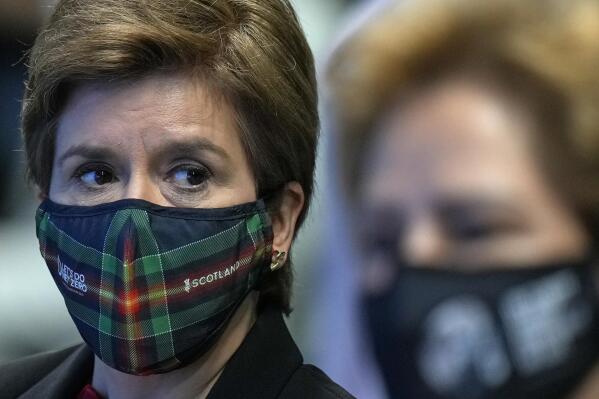 FILE - Scotland's First Minister Nicola Sturgeon, left, attends a meeting at the COP26 U.N. Climate Summit in Glasgow, Scotland, Friday, Nov. 5, 2021. Police said Monday, April 18, 2022 that they spoke to Scotland’s leader to remind her about sticking to coronavirus mask rules after she was filmed without a face covering indoors. (AP Photo/Alastair Grant, File)