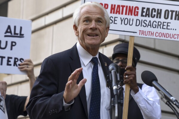 FILE - Former White House trade adviser Peter Navarro speaks to the media as he departs federal court, Tuesday, Sept. 5, 2023, in Washington. Navarro was convicted Thursday, Sept. 7, of contempt of Congress charges filed after he was accused of refusing to cooperate with a congressional investigation into the Jan. 6, 2021, attack on the U.S. Capitol. (AP Photo/Mark Schiefelbein, File)