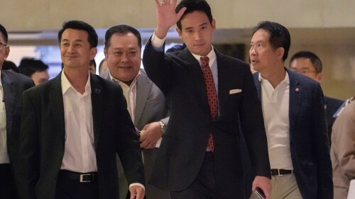 Pita Limjaroenrat, the leader of Move Forward Party, center. and Leader of Pheu Thai party Chonlanan Srikaew, left , wave to supporters after meeting in Bangkok, Thailand, Monday, July 17, 2023. The top candidate to become Thailand's next prime minister, Move Forward Party leader Pita Limjaroenrat, who was rebuffed last week by an initial vote of Parliament, declared Monday he will remain a candidate for a second round of ballot but acknowledges he may have to make way for a political ally if he cannot attract substantially more support. (AP Photo/Sakchai Lalit)