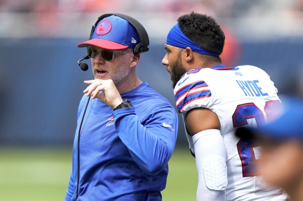 FILE - Buffalo Bills head coach Sean McDermott listens to safety Micah Hyde during an NFL preseason football game against the Chicago Bears, Aug. 26, 2023, in Chicago. The Bills are drawing upon the lingering memories of an emotionally draining season last year by believing they are stronger because of it thanks to the emphasis coach McDermott placed on mental health. (AP Photo/Charles Rex Arbogast, File)