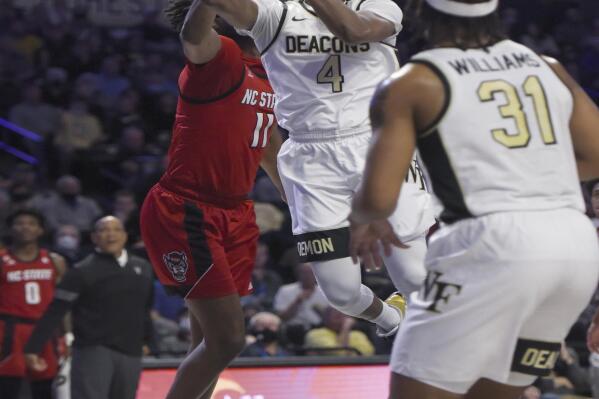 Wake Forest's Daivien Williamson gets past North Carolina State's Jaylon Gibson for a layup during an NCAA college basketball game Wednesday, March 2, 2022 in Winston Salem, N.C. (Walt Unks/The Winston-Salem Journal via AP)