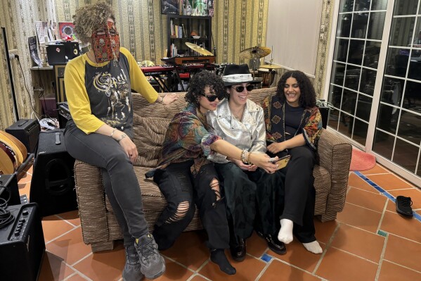 From left, members of the band Seera including Thing, Noura, Hayahuascah and Meesh take a selfie during an interview with The Associated Press in Riyadh, Saudi Arabia, Sunday, May 12, 2024. A public performance by Seera, an all-women psychedelic rock band that blends traditional Arabic melodies with the resurgent psychedelia of bands like Tame Impala, would have been unthinkable just years earlier in the kingdom. (AP Photo/Baraa Anwer)