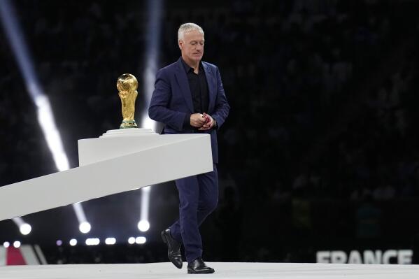France's head coach Didier Deschamps walks past the trophy after receiving his second place medal at the end of the World Cup final soccer match between Argentina and France at the Lusail Stadium in Lusail, Qatar, Sunday, Dec. 18, 2022. Argentina won 4-2 in a penalty shootout after the match ended tied 3-3. (AP Photo/Martin Meissner)