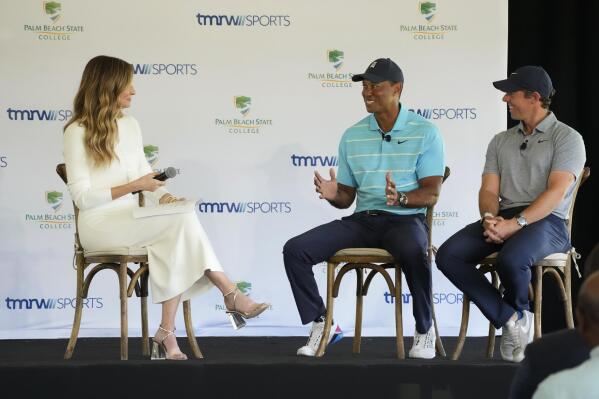 Golfers Tiger Woods, center, and Rory McIlroy, right, talk to host Erin Andrews as they discuss the future home of their tech-infused golf league that will begin play next year, Tuesday, Feb. 21, 2023, on the campus of Palm Beach State College in Palm Beach Gardens, Fla. (AP Photo/Wilfredo Lee)