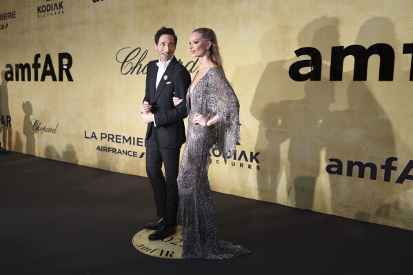 Adrien Brody, left, and Georgina Chapman pose for photographers upon arrival at the amfAR Cinema Against AIDS benefit at the Hotel du Cap-Eden-Roc, during the 78th Cannes international film festival, Cap d'Antibes, southern France, Thursday, May 22, 2025. (Photo by Joel C Ryan/Invision/AP)