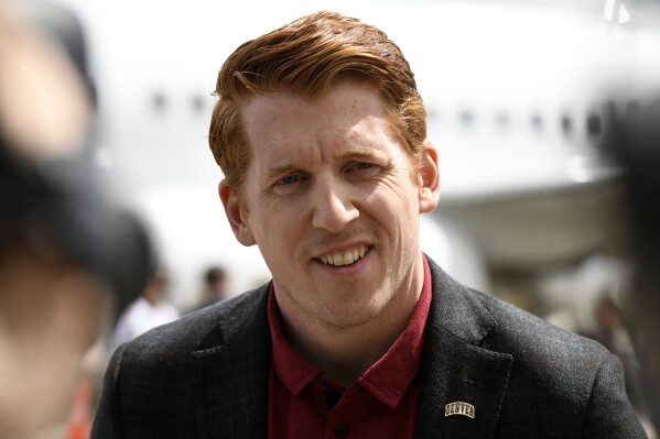 Denver NCAA college hockey head coach David Carle speaks to the media after landing at Denver International Airport, April 10, 2022, in Denver. (Helen H. Richardson/The Denver Post via AP, File)