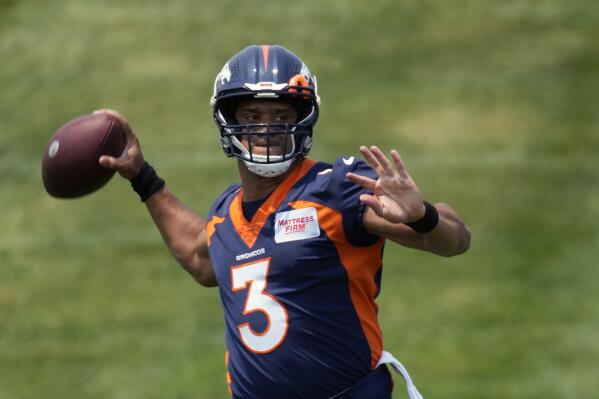 FILE - Denver Broncos quarterback Russell Wilson (3) takes part in drills during the NFL team's practice at the Broncos' headquarters Monday, June 13, 2022, in Centennial, Colo. The Broncos have undergone a major makeover this offseason. It began with Nathaniel Hackett replacing Vic Fangio as head coach and continued with the acquisition of star quarterback Russell Wilson from the Seahawks in exchange for a bevy of players and draft picks. (AP Photo/David Zalubowski, File)