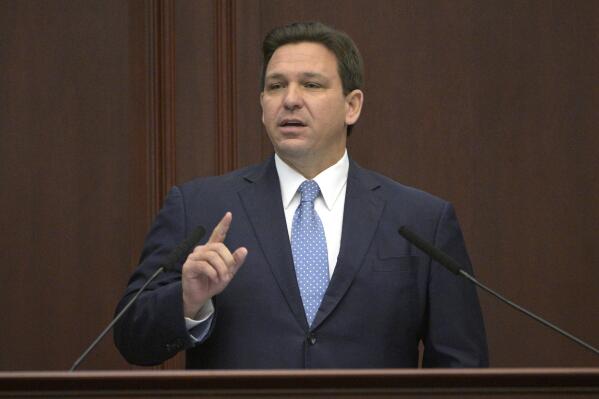 FILE - Florida Gov. Ron DeSantis addresses a joint session of a legislative session, Jan. 11, 2022, in Tallahassee, Fla. Trump is slamming politicians who refuse to say whether they’ve received COVID-19 booster shots, calling them “gutless.” In an interview with One America News Network on Tuesday night, he said unnamed politicians have been afraid to admit they got the booster shot. Trump did not name names, but Florida Gov. Ron DeSantis, who is often mentioned as a possible 2024 presidential contender, has notably declined to say whether he has received a booster.  (AP Photo/Phelan M. Ebenhack, File)