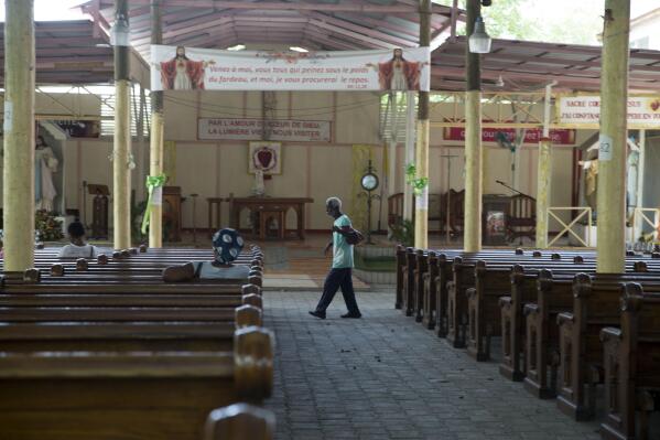 An elderly man walks inside the Sacre Coeur of Turgeau Catholic church in Port-au-Prince, Haiti, Wednesday, April 21, 2021. Catholic institutions including schools and universities closed Wednesday across Haiti as part of a three-day protest to demand the release of nine people including five priests and two nuns kidnapped more than a week ago amid a spike in violence the government is struggling to control. (AP Photo Joseph Odelyn)
