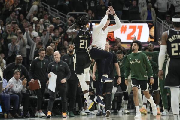 Milwaukee Bucks' Jrue Holiday is congratulated by Pat Connaughton after making a three-point basket in the final minute of the second half of an NBA basketball game against the Detroit Pistons Monday, Oct. 31, 2022, in Milwaukee. The Bucks won 110-108. (AP Photo/Morry Gash)