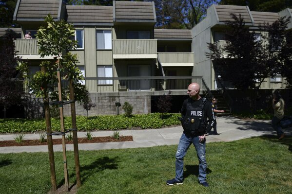 
              Police work the apartment complex believed to be associated with a car crash suspect in Sunnyvale, Calif., on Wednesday, April 24, 2019. Investigators are working to determine the cause of a crash in Northern California that injured eight pedestrians on Tuesday evening. Authorities say the driver of a car was taken into custody after he appeared to deliberately plow into them. (AP Photo/Cody Glenn)
            