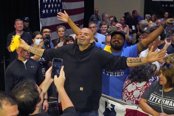 Pennsylvania Lt. Gov. John Fetterman, the Democratic nominee for the state's U.S. Senate seat, center, poses for a photo with supporters after speaking at a rally in Erie, Pa., on Friday, Aug. 12, 2022. (AP Photo/Gene J. Puskar)