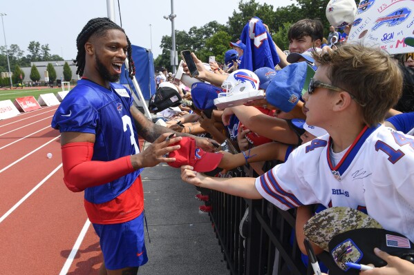 Buffalo Bills safety Damar Hamlin signs autographs after practice at the NFL football team's training camp in Pittsford, N.Y., Wednesday, July 26, 2023. (AP Photo/Adrian Kraus)