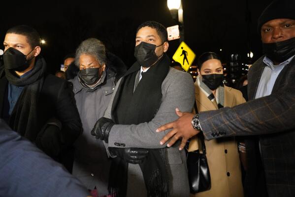 Actor Jussie Smollett, center, along with his mother Janet, second from left, returns to the Leighton Criminal Courthouse, Thursday, Dec. 9, 2021, in Chicago, after a jury reached a verdict in his trial. Smollett was convicted Thursday on five of six charges he staged an anti-gay, racist attack on himself nearly three years ago and then lied to Chicago police about it.(AP Photo/Nam Y. Huh)