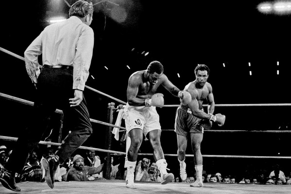 Joe Frazier is staggered by hard right in second round of heavyweight title fight by challenger George Foreman in Kingston, Jamaica, on Jan. 23, 1973. (AP Photo, File)
