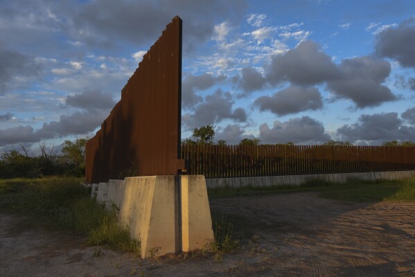 Dusk begins to fall at a section of border fence in Brownsville, Texas, on Wednesday, Nov. 8, 2023. The Biden administration's plan to build new barriers along the U.S.-Mexico border calls for a "movable" design that frustrates both environmentalists and advocates of stronger border enforcement. (AP Photo/Valerie Gonzalez)