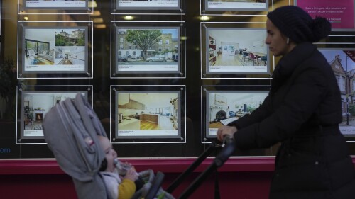 FILE - A woman walks past an estate agent in London, Thursday, Nov. 3, 2022. Homeowners and renters in the U.K. are facing further grim news as mortgage rates hit levels not seen since unfunded tax cuts announced by the government last fall spooked investors. Financial information company Moneyfacts says the average rate for a five-year fixed rate mortgage in the U.K. hit 6.01% on Tuesday, July 4, 2023 from 5.97% the previous day. It comes after the Bank of England has raised interest rates to a 15-year high to battle high inflation. (AP Photo/Kin Cheung, File)