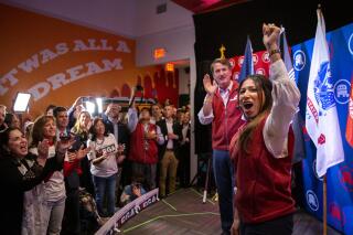 Yesli Vega, right, and Gov. Glenn Youngkin cheer with the crowd during a rally at Gourmeltz in Spotsylvania County, Va., Monday, Oct. 17, 2022. (Tristan Lorei/The Free Lance-Star via AP)