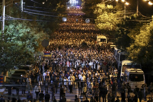 Demonstrators march during a protest against Prime Minister Nikol Pashinyan in Yerevan, Armenia, Sunday, Sept. 24, 2023. Azerbaijan conducted a lightning military offensive In Nagorno-Karabakh, reclaiming full control of it as the result. The events in the breakaway region sparked a wave of protests in Armenia. (Hayk Baghdasaryan/Photolure via AP)