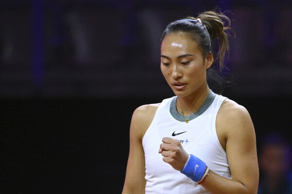 China's Qinwen Zheng raises a fist during the Porsche Tennis Grand Prix WTA tennis tournament in Stuttgart, Germany, Tuesday, April 16, 2024. (Marijan Murat/dpa via AP)