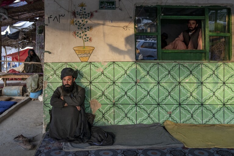 Restaurant workers wait for customers in a market in Afghanistan, on Sunday, Feb. 26, 2023. (AP Photo/Ebrahim Noroozi)