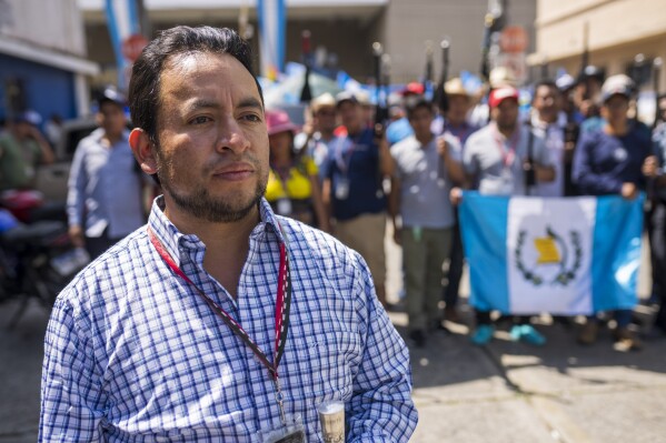 Luis Pacheco, President of the K'iche' Indigenous organization "48 Cantones de Totonicapan," poses for photos with Mayors, who are members of the organization, outside the Attorney General's headquarters in Guatemala City, Oct. 11, 2023. The "48 Cantones de Totonicapán" is an Indigenous organization that has been leading the national protests asking for the resignation of Guatemala's Attorney General Consuelo Porras for her attempts to invalidate the recent presidential election. (AP Photo/Moises Castillo, File)