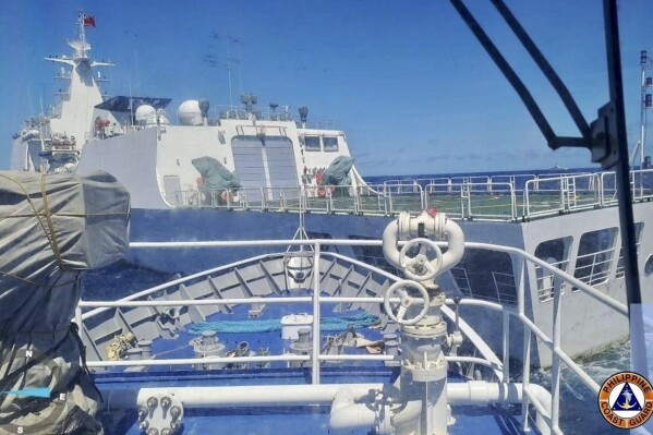 In this photo provided by the Philippine Coast Guard, a Chinese Coastguard ship, front, allegedly blocks the path of a Philippine Coast Guard ship near the Philippine-occupied Second Thomas Shoal, South China Sea during a re-supply mission on Saturday Aug. 5, 2023. The Philippine military condemned on Sunday a Chinese coast guard ship's 