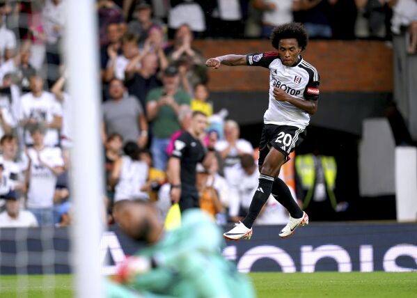 Fulham's Willian celebrates scoring his side's third goal of the game , during the English Premier League soccer match between Fulham and Sheffield United, at Craven Cottage, London, Saturday, Oct. 7, 2023. ( John Walton/PA via AP)