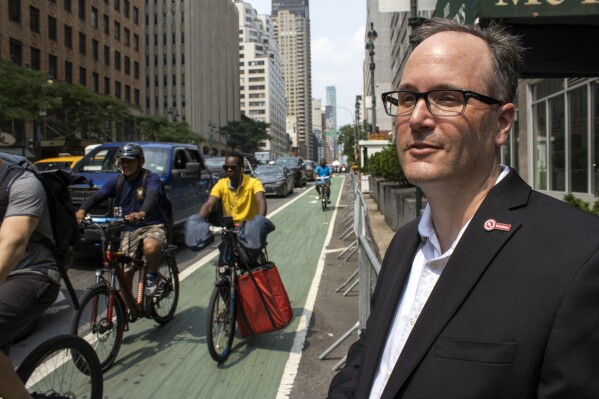 Robert Slone chief scientist and senior vice president of UL Solutions stands by a bike lane as riders on e-bikes pass by on 2nd Avenue in Manhattan in New York on Monday July 17 2023 Amid a rash of e-bike lithium-ion battery fire deaths the city will require all e-bikes sold here to be deemed safe by an independent testing company such as UL Solutions AP PhotoTed Shaffrey