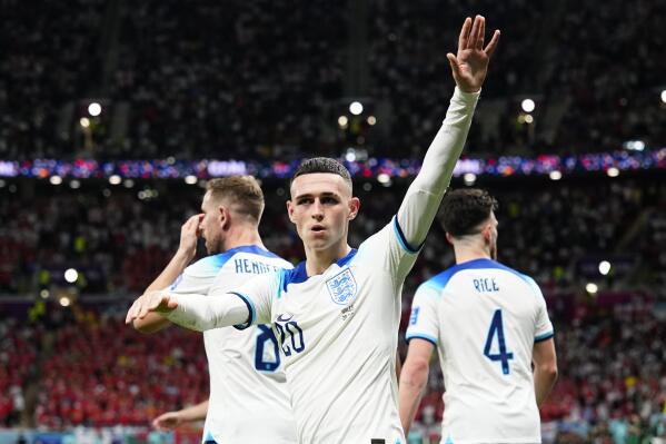 England's Phil Foden waves towards the fans after scoring his side's second goal during the World Cup group B soccer match between England and Wales, at the Ahmad Bin Ali Stadium in Al Rayyan, Qatar, Tuesday, Nov. 29, 2022. (AP Photo/Pavel Golovkin)