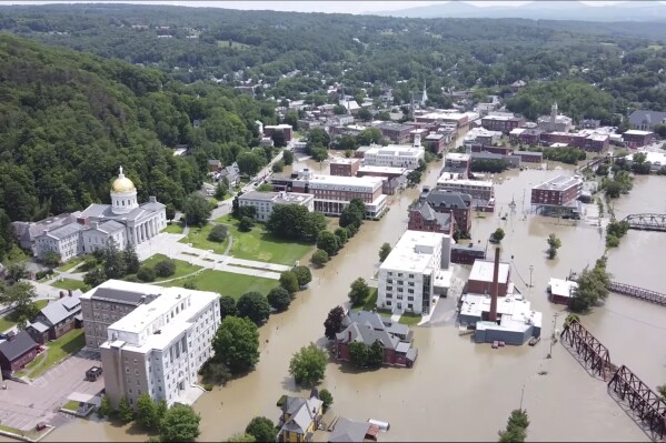 FILE — This image made from drone footage provided by the Vermont Agency of Agriculture, Food and Markets shows flooding in Montpelier, Vt., Tuesday, July 11, 2023. The Vermont legislature is advancing a bill that would require fossil fuel producers to pay for some of the state's recovery costs from climate-related storms. (Vermont Agency of Agriculture, Food and Markets via AP, File)